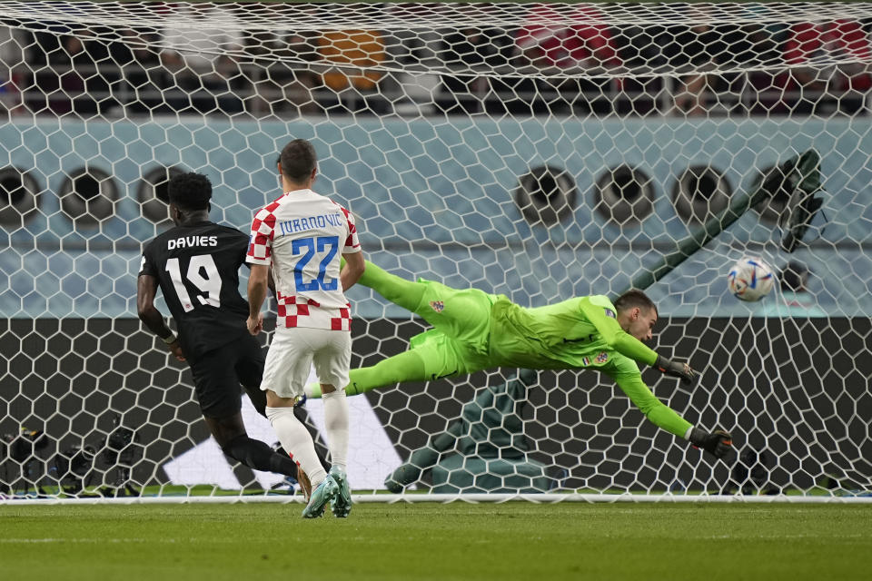 Canada's Alphonso Davies, left, scores the opening goal during the World Cup group F soccer match between Croatia and Canada, at the Khalifa International Stadium in Doha, Qatar, Sunday, Nov. 27, 2022. (AP Photo/Martin Meissner)