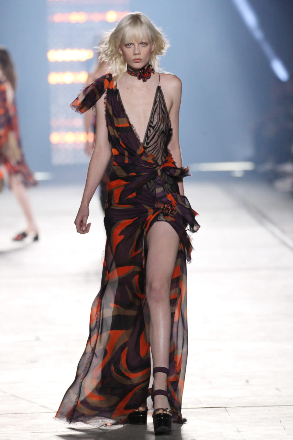 A model wears a red and black chiffon evening dress at Versace’s spring 2016 show.