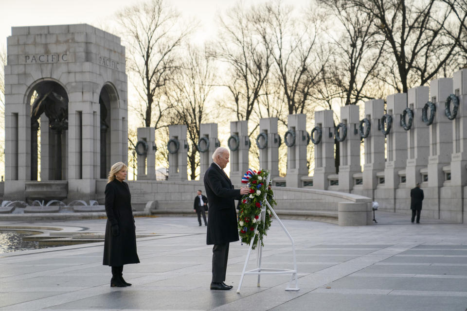 President Joe Biden and first lady Jill Biden visit the National World War II Memorial to mark the 80th anniversary of the Japanese attack on Pearl Harbor, Tuesday, Dec. 7, 2021, in Washington. (AP Photo/Evan Vucci)