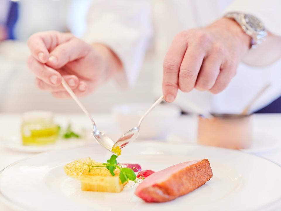 Someone plating up a meal aboard The World.