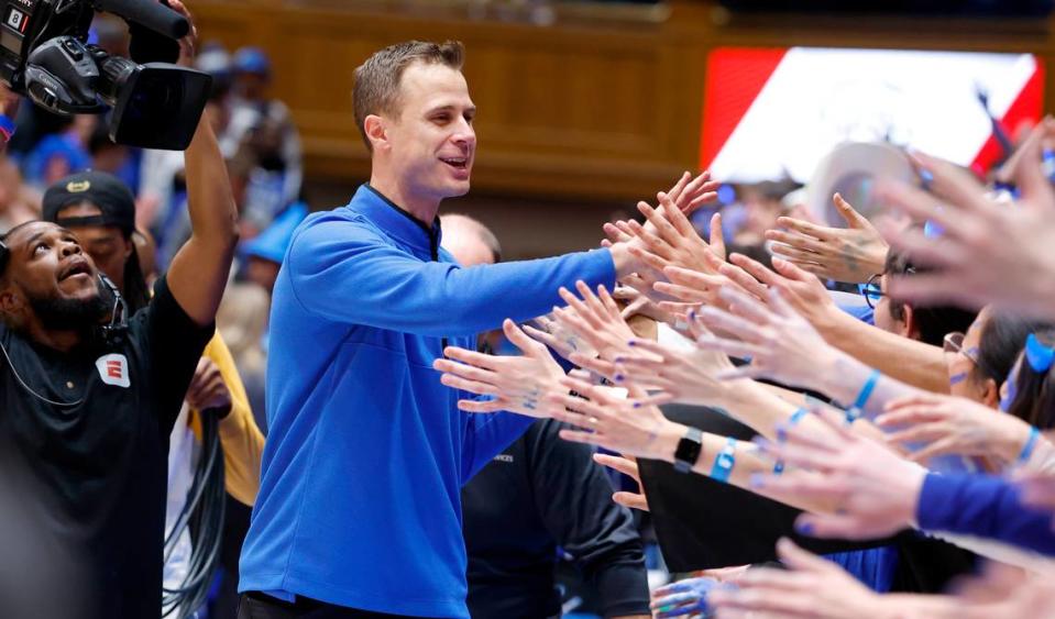 Duke head coach Jon Scheyer greets the fans after Duke’s 63-57 victory over UNC at Cameron Indoor Stadium in Durham, N.C., Saturday, Feb. 4, 2023.