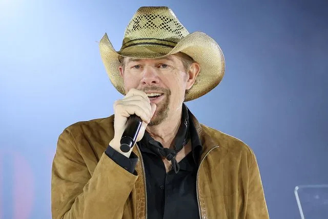<p>Jason Kempin/Getty Images</p> Toby Keith performing in Nashville in November 2022