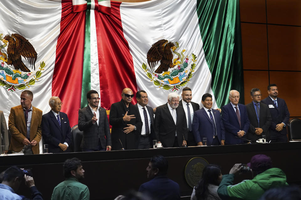 Mexican Journalist Jaime Maussan, center, together with Congressman Sergio Gutierrez Luna and other legislators present what they claim are extraterrestrial life forms on a screen, at the Chamber of Deputies in Mexico City, Tuesday, Nov. 7, 2023. Mexican legislators held another hearing dedicated to the potential for extraterrestrial life forms and UFOs following a controversial spectacle in September in which Maussan displayed what he said were "non-human beings that are not part of our terrestrial evolution." (AP Photo/Marco Ugarte)
