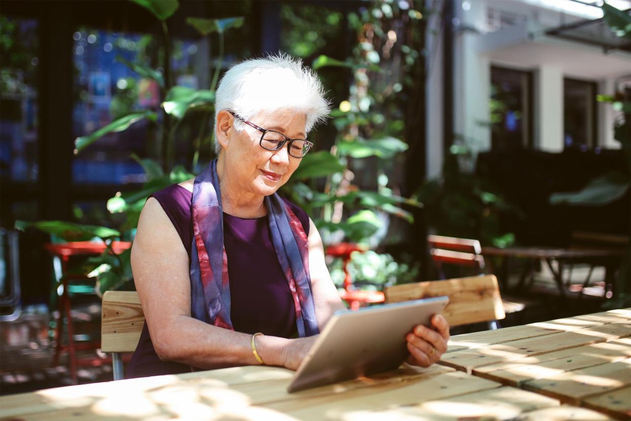 Senior woman outside on her tablet