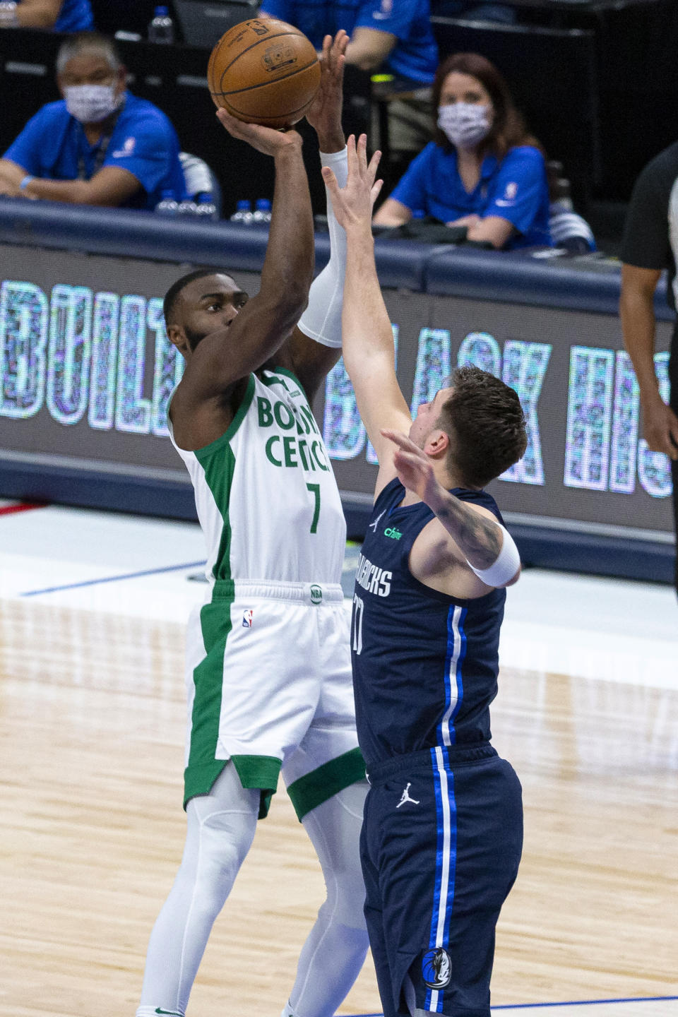 Boston Celtics guard Jaylen Brown (7) shoots as Dallas Mavericks guard Luka Doncic (77) defends during the first half of an NBA basketball game in Dallas, Tuesday, Feb. 23, 2021. (AP Photo/Sam Hodde)