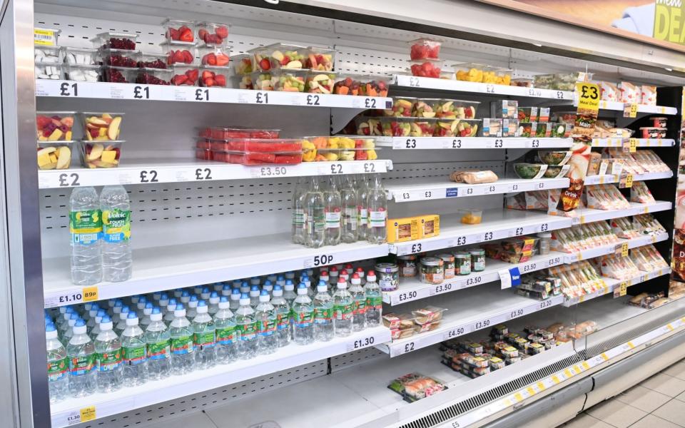 Mandatory Credit: Photo by FACUNDO ARRIZABALAGA/EPA-EFE/Shutterstock (12226490c) Food yet to be shelved at a supermarket in London, Britain, 22 July 2021. British supermarkets are struggling to stock shelves as staff shortages take their toll due to the so called 'pingdemic'. With so many staff going into self isolation after being pinged by the NHS app, supermarkets are now under increasing pressure to keep shelves fully stocked. The British government is being urged to allow supermarket staff to be exempt from self-isolation rules. Pingdemic in the UK, London, United Kingdom - Shutterstock