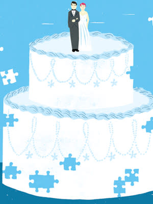 white wedding cake on a blue background with a couple cake topper