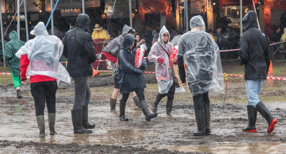 People walking in the mud and rain