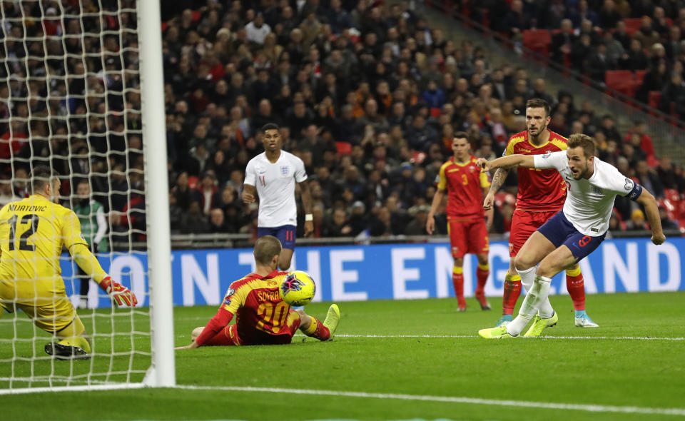 England's Harry Kane, right, scores the fifth goal during the Euro 2020 group A qualifying soccer match between England and Montenegro at Wembley stadium in London, Thursday, Nov. 14, 2019. (AP Photo/Kirsty Wigglesworth)