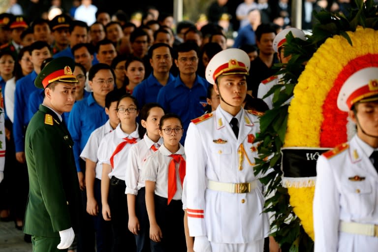 Schoolchildren queue at the national funeral house to pay respects to late president Tran Dai Quang