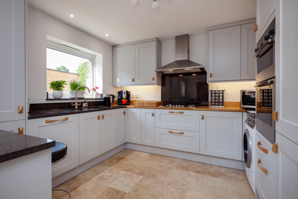 large kitchen with cabinets and doors created with a smaller box outline