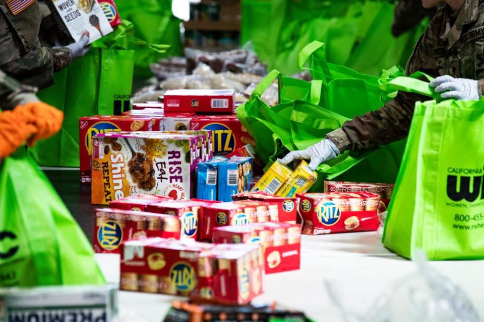 National guard troops soldiers bag food that will be delivered to people in need at the Find food bank amid the coronavirus crisis in Indio, California.