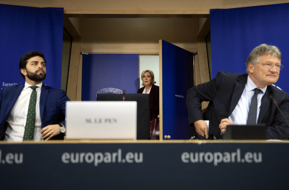 French far-right National Rally leader and MEP Marine Le Pen, center, arrives to a media conference to announce the formation of a new far-right European Parliament group at the European Parliament in Brussels, Thursday, June 13, 2019. (AP Photo/Virginia Mayo)