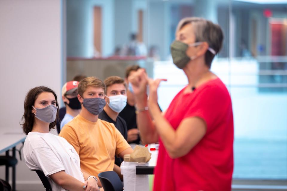 Brady Evans, a senior from Milford, looks on as professor Jane Sojka teaches her professional selling class at the Lindner College of Business on the campus of the University of Cincinnati on Monday, Aug. 23, 2021.