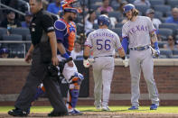 Texas Rangers' Kole Calhoun (56) celebrates with Jonah Heim, right, after hitting a solo home run off New York Mets starting pitcher Trevor Williams (29) in the fourth inning of a baseball game, Saturday, July 2, 2022, in New York. (AP Photo/John Minchillo)