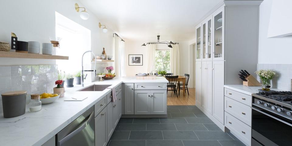 <p>The kitchen's dark, red brick wall was completely concealed and the dated tile floors were covered with slate, for a look inspired by Aisling's honeymoon in Scandinavia.</p>