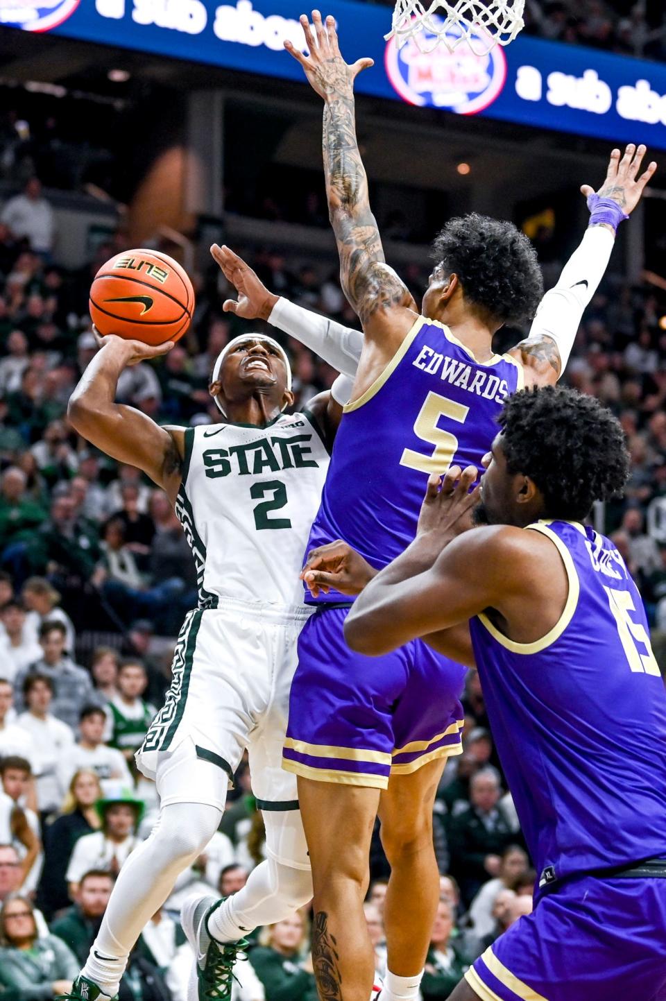 Michigan State's Tyson Walker, left, shoots as James Madison's Terrence Edwards, Jr. defends during the first half on Monday, Nov. 6, 2023, in East Lansing.