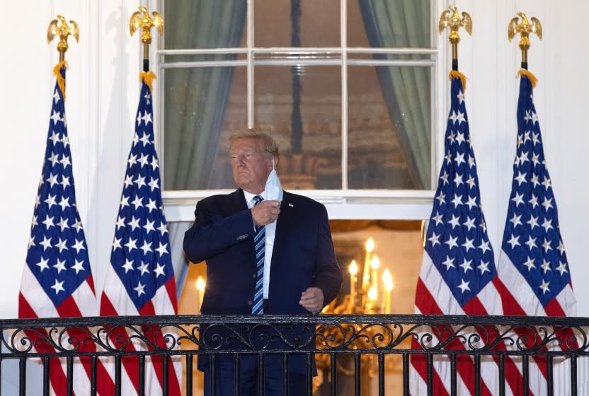 WASHINGTON, DC - OCTOBER 05: U.S. President Donald Trump removes his mask upon return to the White House from Walter Reed National Military Medical Center on October 05, 2020 in Washington, DC. Trump spent three days hospitalized for coronavirus. (Photo by Win McNamee/Getty Images)