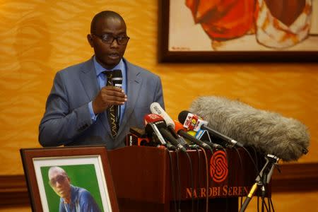 Tom Kabau the brother of Kenyan George Kabau who died in the Ethiopian Airlines crash sit next to his picture during a news conference where his lawyers announced they plan to file a wrongful-death lawsuit against Boeing, at the Serene hotel in Nairobi, Kenya April 16, 2019. REUTERS/Baz Ratner