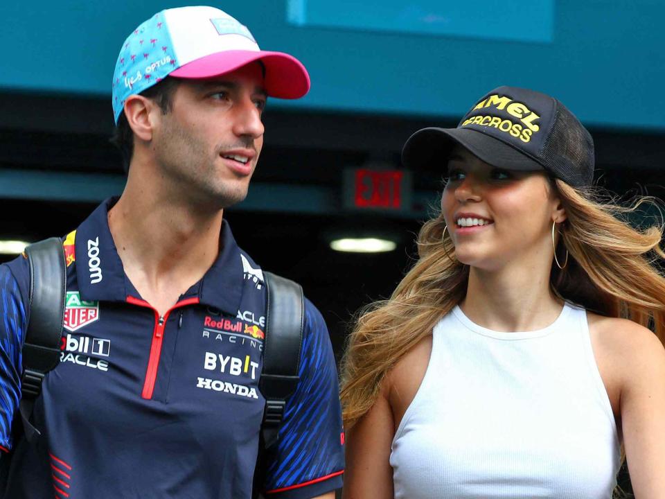 <p>James Moy/Alamy</p> Daniel Ricciardo and Heidi Berger during the Miami Grand Prix in 2023.