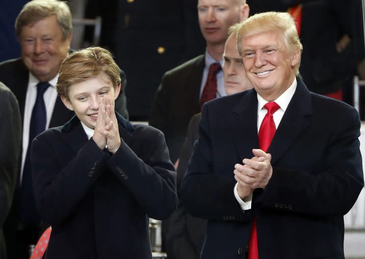 President Donald Trump, right, smiles with his son Barron as they view the 58th Presidential Inauguration parade for President Donald Trump in Washington. Friday, Jan. 20, 2017 (Photo: Pablo Martinez Monsivais)