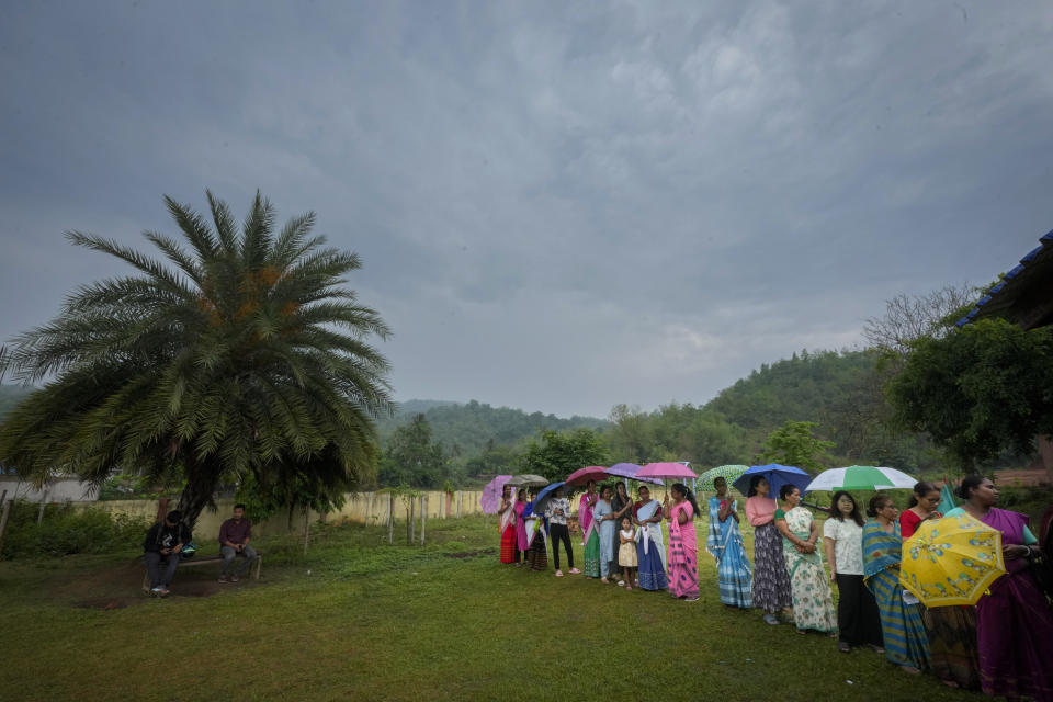 Assamese women voters stand in queue to cast their votes at a polling station during the third phase of general election on the outskirts of Guwahati, India, Tuesday, May 7, 2024. (AP Photo/Anupam Nath)