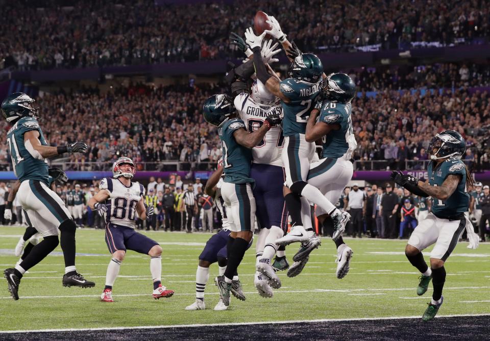 New England Patriots tight end Rob Gronkowski (87) together with Philadelphia Eagles free safety Rodney McLeod (23) and cornerback Jaylen Watkins (26) jump for a pass in the end zone, during the second half of the NFL Super Bowl 52 football game, Sunday, Feb. 4, 2018, in Minneapolis. The Eagles won 41-33. (AP Photo/Tony Gutierrez)