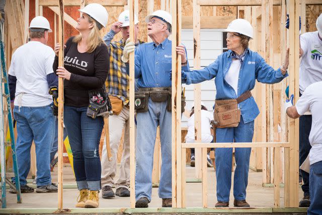 <p>Habitat for Humanity International/Ezra Millstein</p> Trisha Yearwood and Garth Brooks working with Habitat for Humanity in 2016