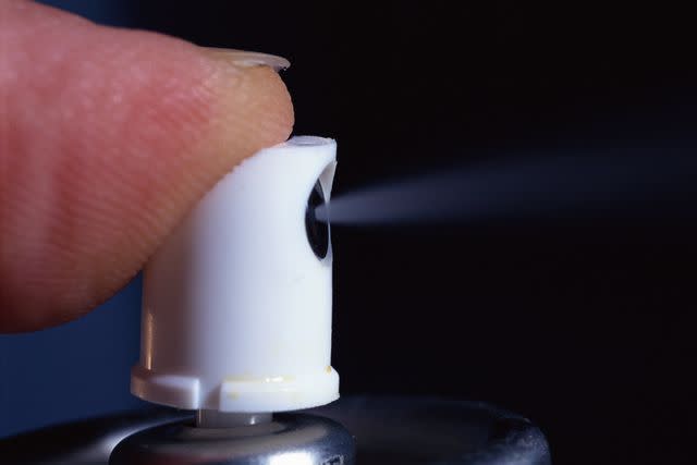 <p>Getty</p> Stock image of someone spraying an aerosol spray can