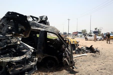 Destroyed vehicles are seen at the site of a suicide car bomber in Khalis, north of Baghdad, Iraq, July 25, 2016. REUTERS/Stringer