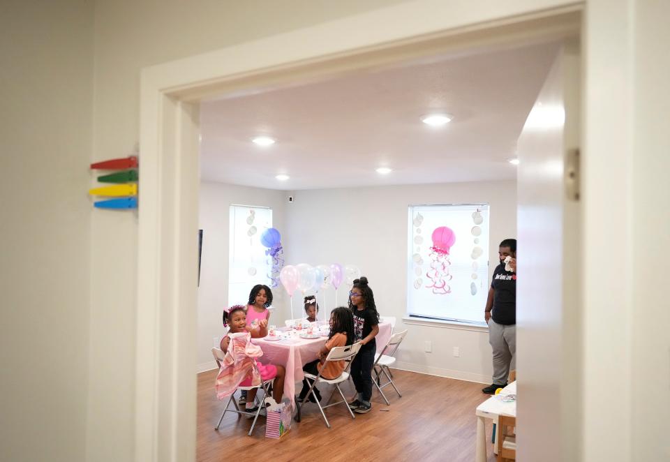 Amali Rowe 9, left, opens gifts at her birthday party with her homeschool classmates, left to right, Onyx Dydell, 3, Madeleine Wilson, 5, Nala Dydell, 7, and Derry Dydell III, 5, at Black Mamas Village ATX which is in a building previously occupied by Whole Women’s Health abortion clinic in Austin Thursday May 23, 2024.