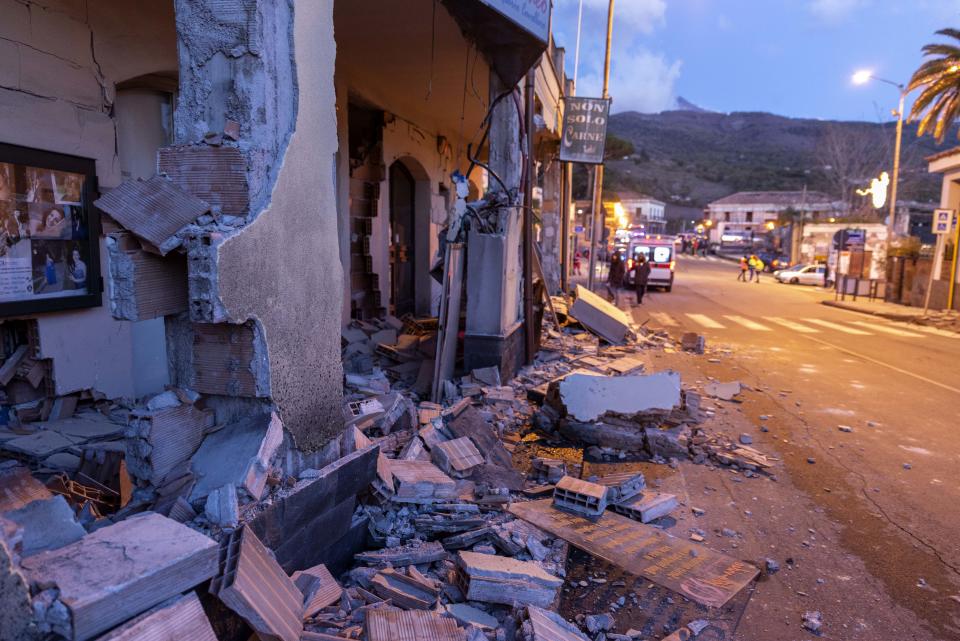 Debris of a partially collapsed house sit on the street in Fleri, Sicily Italy, Wednesday, Dec. 26, 2018. A quake triggered by Italy's Mount Etna volcano has jolted eastern Sicily, slightly injuring 10 people and prompting frightened Italian villagers to flee their homes. (AP Photo/Salvatore Allegra)