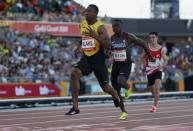 Athletics - Gold Coast 2018 Commonwealth Games - Men's 100m - Heats - Carrara Stadium - Gold Coast, Australia - April 8, 2018. Yohan Blake of Jamaica runs ahead of Sam Effah of Canada. REUTERS/Paul Childs