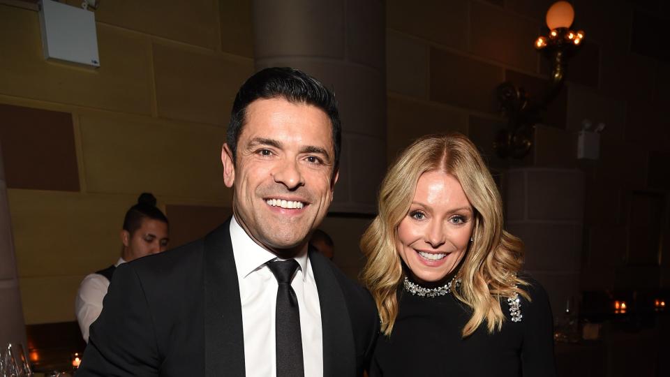 mark consuelos and kelly ripa holding hands while attending event