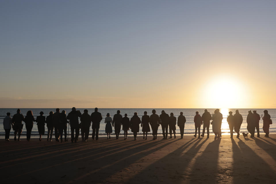 World War II reenactors gather on Omaha Beach in Saint-Laurent-sur-Mer, Normandy, France Monday, June 6, 2022, the day of 78th anniversary of the assault that helped bring an end to World War II. (AP Photo/Jeremias Gonzalez)