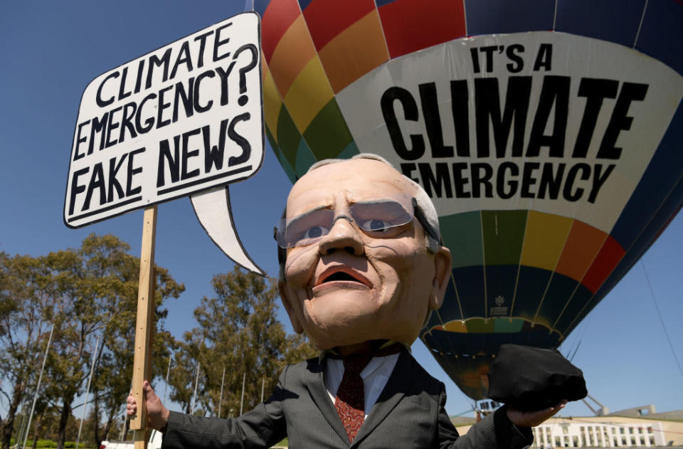 A mannequin of Prime Minister Scott Morrison holding a lump of coal with a hot air ballon with 'Climate Emergency' on it, during a protest in front of Parliament House on Oct. 15 2019 in Canberra, Australia.<span class="copyright">Tracey Nearmy—Getty Images</span>