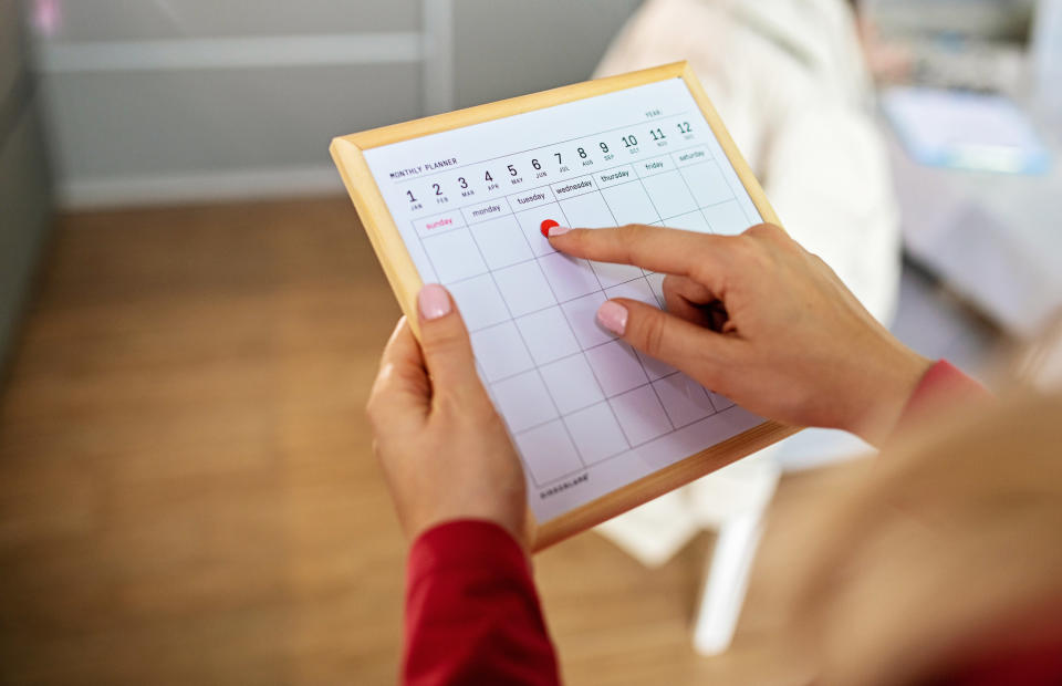 A person looking at a calendar