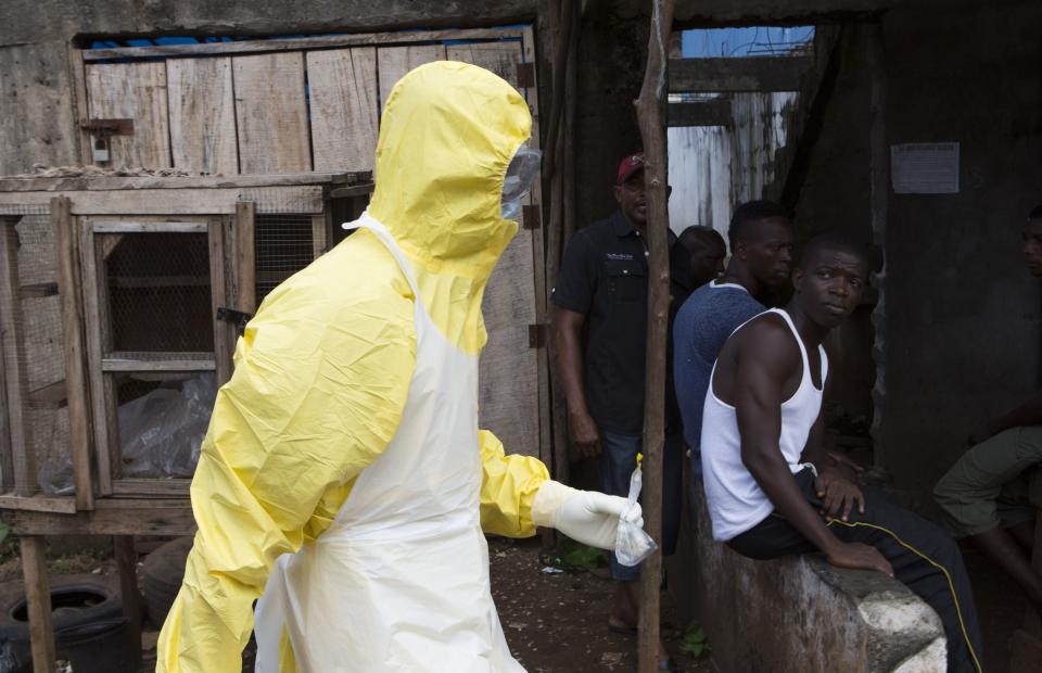 A health worker in protective equipment carries a sample taken from the body of someone who is suspected to have died from Ebola virus, near Rokupa Hospital, Freetown October 6, 2014. More than 4,000 people have died of the viral haemorrhagic fever in West Africa, mostly in Liberia, neighbouring Sierra Leone and Guinea. Picture taken October 6, 2014. REUTERS/Christopher Black/WHO/Handout via Reuters (SIERRA LEONE - Tags: DISASTER HEALTH) ATTENTION EDITORS - THIS PICTURE WAS PROVIDED BY A THIRD PARTY. REUTERS IS UNABLE TO INDEPENDENTLY VERIFY THE AUTHENTICITY, CONTENT, LOCATION OR DATE OF THIS IMAGE. FOR EDITORIAL USE ONLY. NOT FOR SALE FOR MARKETING OR ADVERTISING CAMPAIGNS. THIS PICTURE IS DISTRIBUTED EXACTLY AS RECEIVED BY REUTERS, AS A SERVICE TO CLIENTS