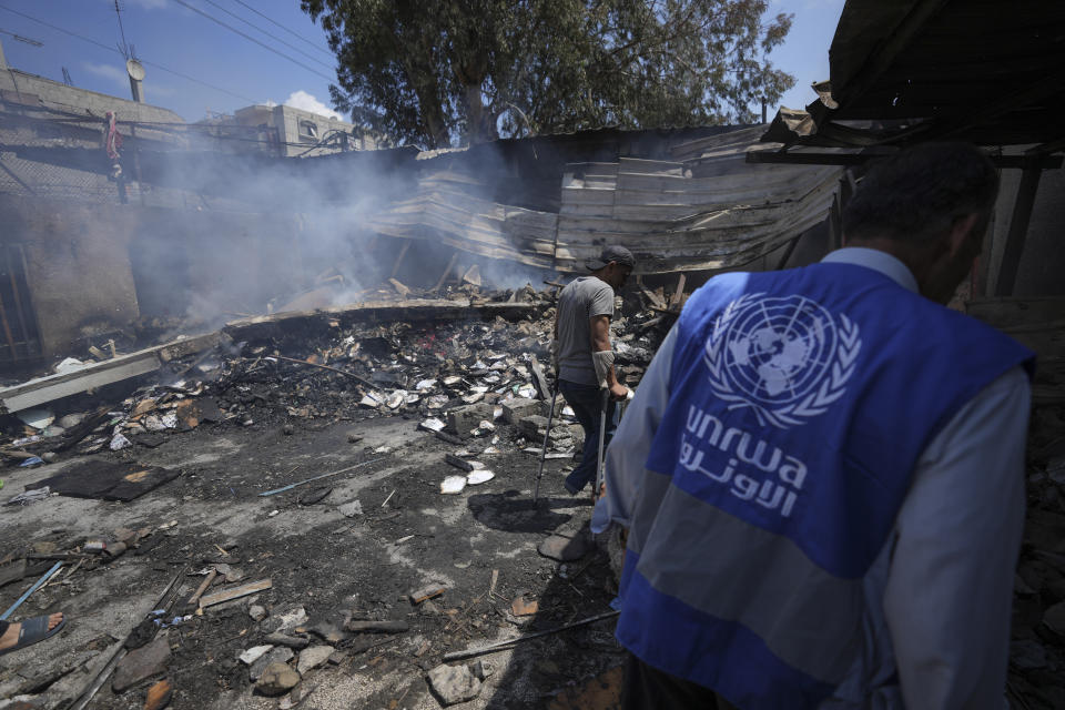 Palestinians look at the destruction after an Israeli strike on a school run by UNRWA, the U.N. agency helping Palestinian refugees, in Nuseirat, Gaza Strip, Tuesday, May 14, 2024. (AP Photo/Abdel Kareem Hana)