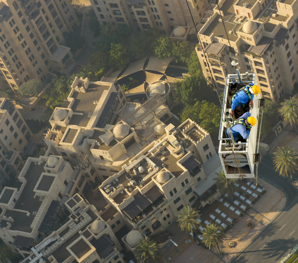 Two laid-back workmen were spotted hanging by two wires from one of the city’s tallest skyscrapers as they went about their daily business. The palm-sweating images were taken by Zohaib Anjum at the Address Downtown building in Dubai. (SWNS)