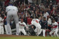 Atlanta Braves' Eddie Rosario (8) celebrates after hitting a three run home run during the fourth inning in Game 6 of baseball's National League Championship Series against the Los Angeles Dodgers Saturday, Oct. 23, 2021, in Atlanta. (AP Photo/Brynn Anderson)