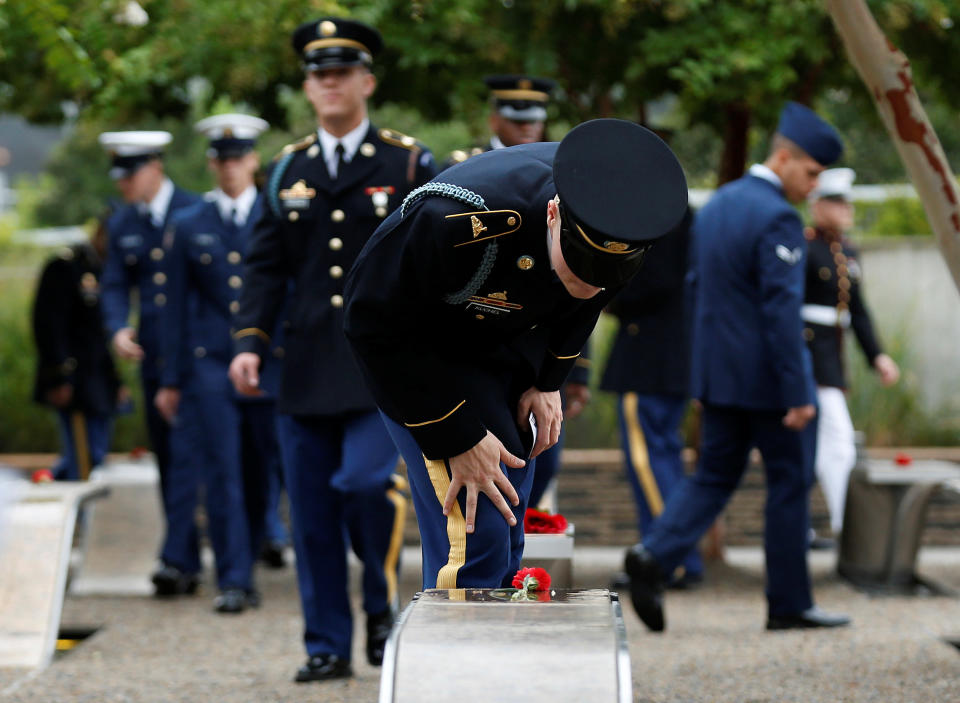 <p>A member of the U.S. Army checks the name on a memorial bench during the 17th annual September 11 observance ceremony at the Pentagon in Washington, Sept. 11, 2018. (Photo: Joshua Roberts/Reuters) </p>