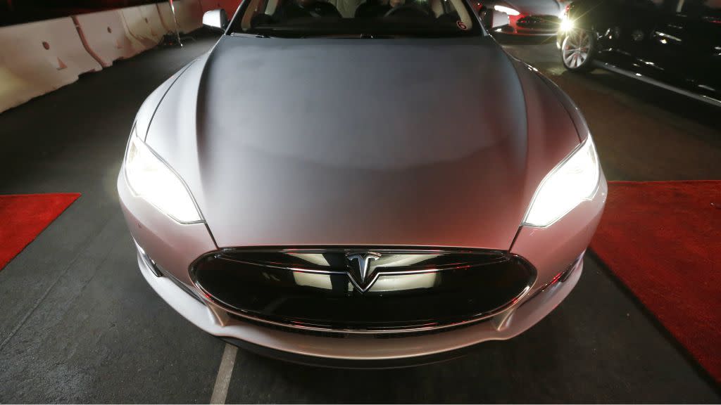 New all-wheel-drive versions of the Tesla Model S car are lined up for test drives in Hawthorne, California October 9, 2014. Tesla Motors Inc on Thursday took its first step toward automated driving, unveiling features that will allow its electric sedan to park itself and sense dangerous situations. The company also said it will roll out an all-wheel drive option of the Model S sedan that can go from zero to 60 miles per hour in 3.2 seconds yet doesn't compromise the vehicle's efficiency. CEO Elon Musk said "D" stands for "dual motor," meaning Tesla's all-wheel drive vehicle will have a motor at either end of the chassis to increase control.