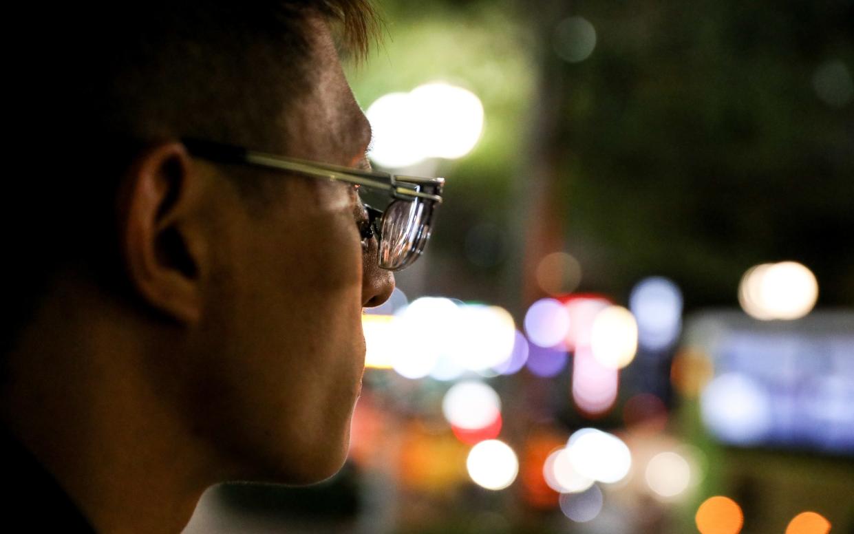 A Taiwanese human trafficking victims from Cambodia, standing on a street in Taipei, Taiwan, after escaping his captors