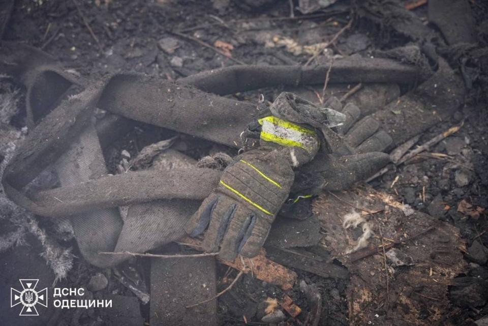 A burnt protective glove is seen among the wreckage of a building while Ukrainian firefighters extinguish the fire at the site after the Russian attacks targeting in different locations around the country, killing and injuring civilians, destroying buildings and cars and causing fires in Odesa, Ukraine on March 15, 2024. (State Emergency Service of Ukraine / Handout/Anadolu via Getty Images)