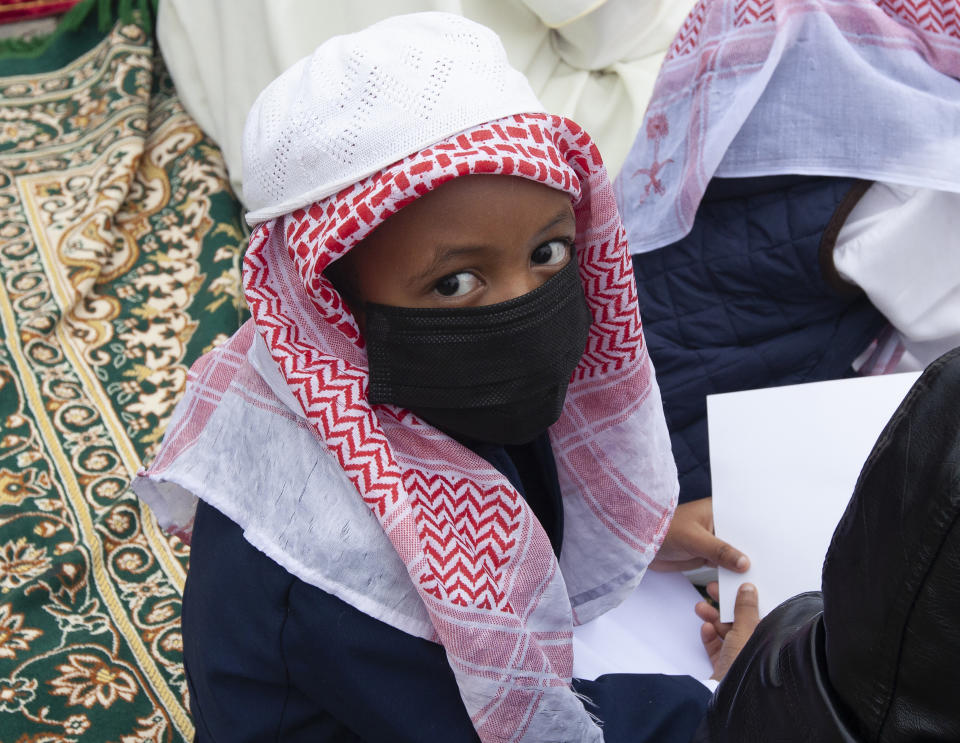 A muslim child attends prayers to celebrate Eid al-Adha, or Feast of Sacrifice, that commemorates the Prophet Ibrahim's faith in Nairobi, Kenya, Tuesday, July 20, 2021. Eid al-Adha marks the end of hajj. (AP Photo/Sayyid Abdul Azim)