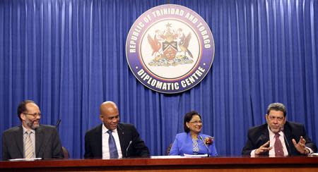 Saint Vincent and the Grenadines' Prime Minister Ralph Gonsalves (R) addresses a media conference, with CARICOM Secretary-General Irwin LaRocque, Haitian President Michel Martelly, and Trinidad and Tobago's Prime Minister and chairperson of the Caribbean Community (CARICOM) Kamla Persad-Bissessar (L-2nd R) at the Diplomatic Centre, St Ann's, on the outskirts of the capital Port-of-Spain, November 26, 2013. REUTERS/Andrea De Silva