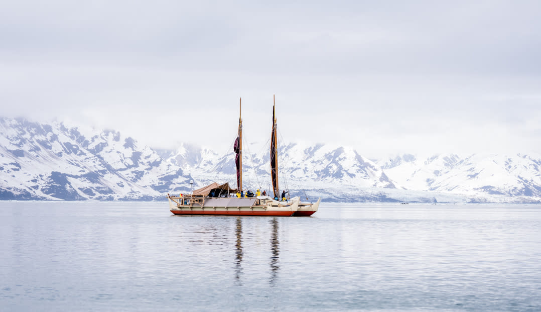 The Hōkūleʻa sits in Disenchantment Bay, about seven miles from the Hubbard Glacier. This voyage marked the furthest northern latitude the Hōkūleʻa has ever traveled in three decades of sailing. (Photo: Chris Blake)