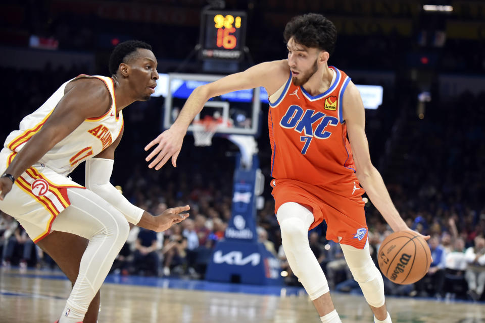 Oklahoma City Thunder forward Chet Holmgren, right, pushes past Atlanta Hawks forward Onyeka Okongwu, left, in the second half of an NBA basketball game, Monday, Nov. 6, 2023, in Oklahoma City. (AP Photo/Kyle Phillips)