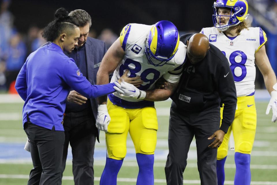 Rams tight end Tyler Higbee (89) is helped off the field after injuring his knee in an NFC wild-card playoff game.
